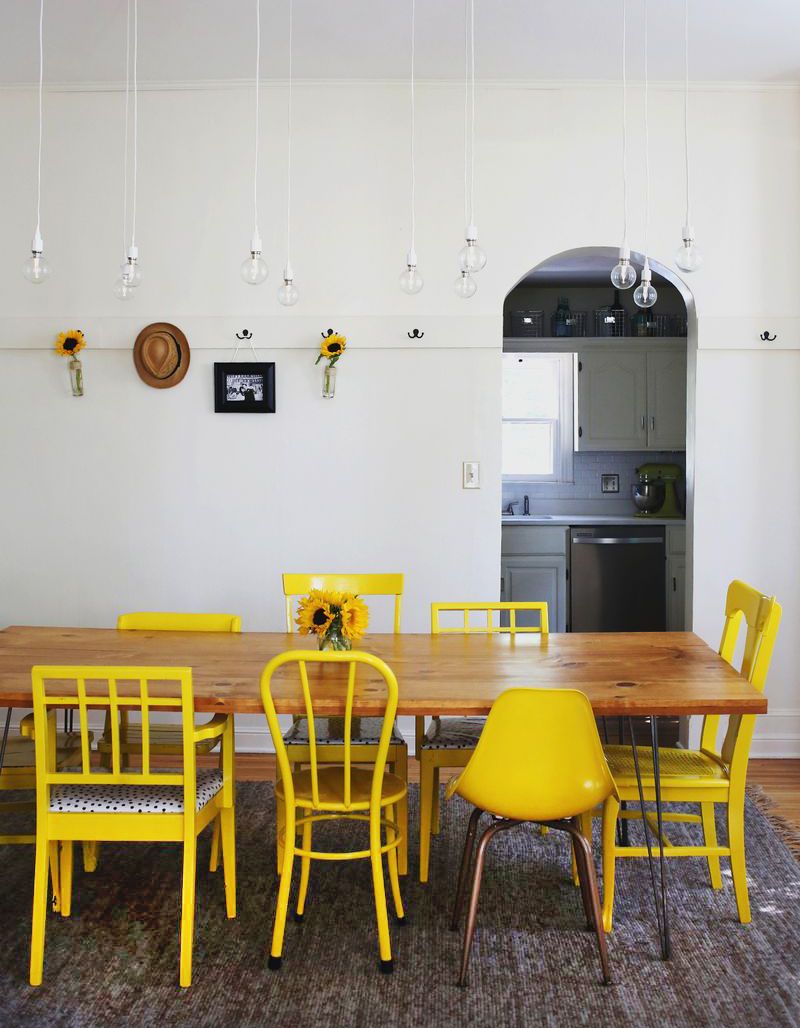 Yellow Mismatched Chairs around Reclaimed Table on Hairpin Legs - Grain and Frame