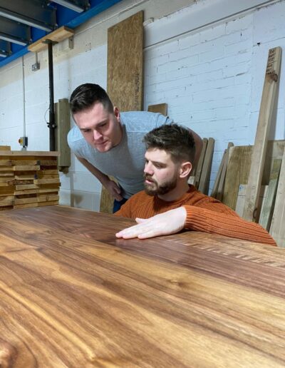 Sam and Rhys, the founders of Grain & Frame, checking an oak table top at the Oldbury unit
